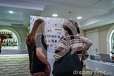 Ladies at an Insta board near a bar Editorial Stock Photo