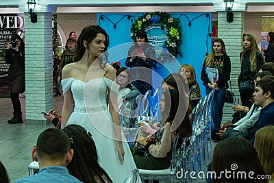A bride model in a white wedding dress staying among guests Editorial Stock Photo