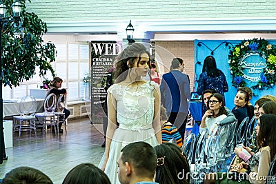 A bride model demonstrates a white wedding dress to guests Editorial Stock Photo