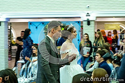 A groom and a bride models in wedding clothes passing the guests Editorial Stock Photo