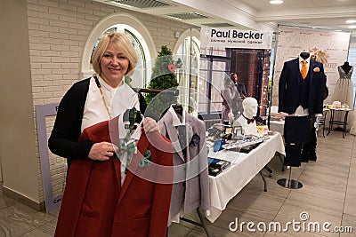 A wedding business lady shows a red wedding suit Editorial Stock Photo