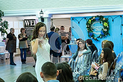 A bride model in a specific pose demonstrates a white wedding dress Editorial Stock Photo