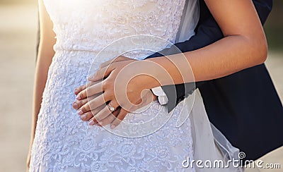 Wedding, hug and hands of couple with ring for marriage ceremony, commitment and trust outdoors. Love, relationship and Stock Photo