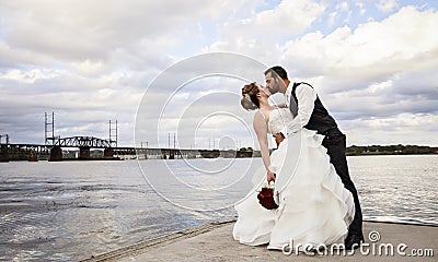 Wedding kiss on dock Stock Photo