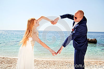 Wedding married couple of hands make a real heart Stock Photo