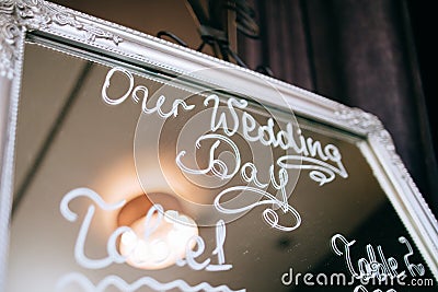 Wedding mirror board with guest list and table numbers on it Stock Photo