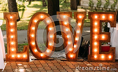 Wedding photo zone glowing love letters retro lamps Stock Photo