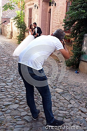 Wedding photographer taking a photo of a married couple Editorial Stock Photo