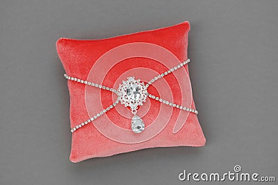 Wedding Pillow for Rings decorated with jewel. Luxury pillow in coral color Stock Photo