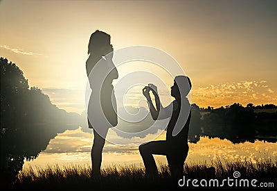 Wedding proposal concept. Young couple have dating at sun set. Stock Photo