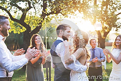 Bride and groom dancing at wedding reception outside in the backyard. Stock Photo