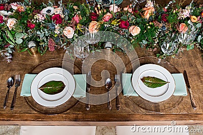 Wedding reception table setting with flower arrangements Stock Photo