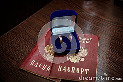 Wedding ring. Two gold vintage rings of the bride and groom are in a blue velvet box and a passport of the Russian Federation Stock Photo