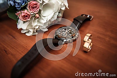 Wedding ring and watch groom on the table Stock Photo