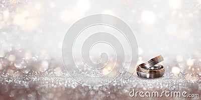 Wedding rings on an abstract silver glittering bokeh background Stock Photo