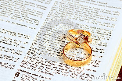 Wedding rings on Bible Stock Photo