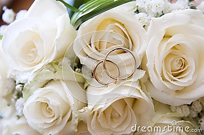 Wedding rings on a bouquet of roses Stock Photo