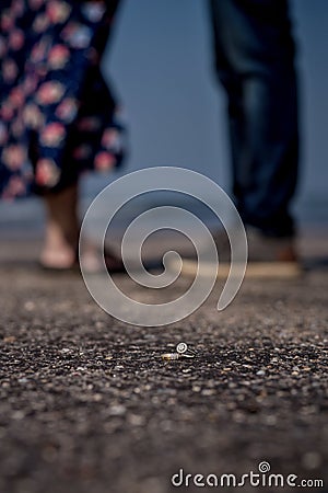 Wedding rings with couple standing in the background Stock Photo