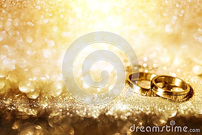 Wedding rings on festive golden background Stock Photo