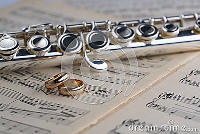 Wedding rings with Flute on old notes background for graphic and web design, Modern background. Internet concept. Trendy Stock Photo
