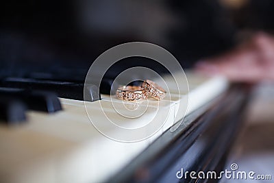 Wedding rings lie on the piano keys Stock Photo