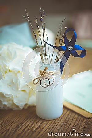 Wedding rings on a mat bottle on background wooden table Stock Photo