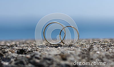Wedding rings placed on a rock Stock Photo