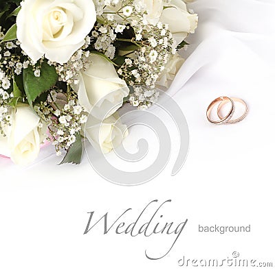 Wedding rings and roses bouquet Stock Photo