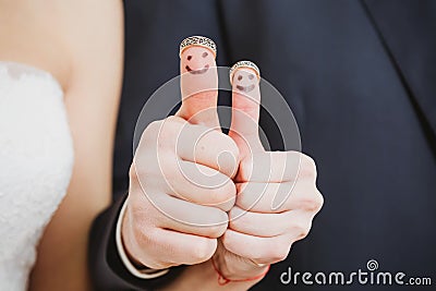 Wedding rings on their fingers painted with the Stock Photo