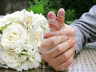 Wedding rings on their fingers people marrieds bride and groom, painted funny little men Stock Photo