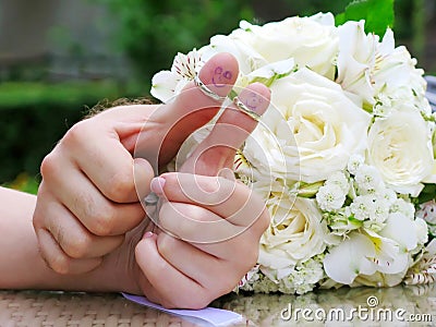 Wedding rings on their fingers people marrieds bride and groom, painted funny little men Stock Photo