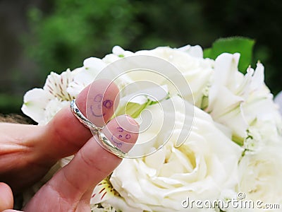 Wedding rings on their fingers people marrieds bride and groom, painted funny little men Stock Photo