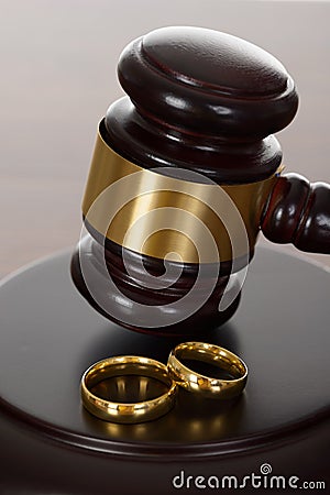 Wedding rings and wooden gavel Stock Photo