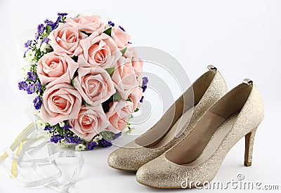Wedding shoes and a bouquet of flowers Stock Photo