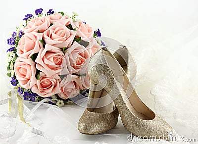 Wedding shoes and a bouquet of flowers Stock Photo