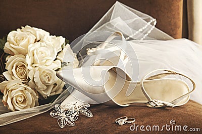 Wedding shoes with bouquet of white roses and ring Stock Photo
