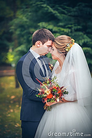 Wedding shot of bride and groom in park Stock Photo