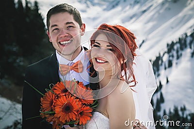 Wedding snowboarders couple just married at mountain winter Stock Photo