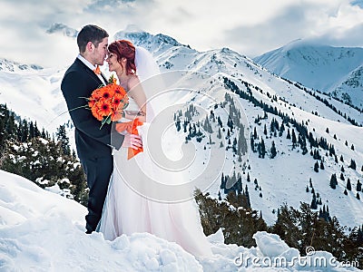 Wedding snowboarders couple just married at mountain winter Stock Photo