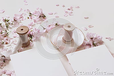 Wedding spring mockup scene with pink blossoming Japanese cherry tree branches, petals and silk ribbons on ceramic plate Stock Photo