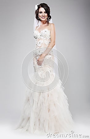 Wedding Style. Sophisticated Newlywed in White Bridal Dress. Elegance Stock Photo