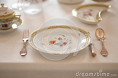 Wedding table decoration with expensive retro royal majesty porcelain service plates and cutlery in a palace Stock Photo