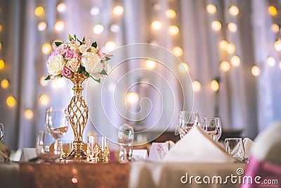 Wedding table with exclusive floral arrangement prepared for reception, wedding or event centerpiece in rose gold color Stock Photo