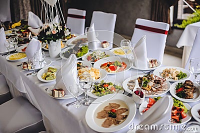 Wedding table, food, drinks, water. Table with silver and glass stemware at restaurant before starting to celebrate a wedding.. Stock Photo