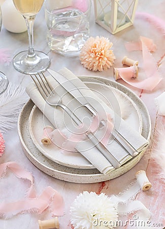 Wedding Table place near flowers, silk ribbons and feathers on a marble table Stock Photo