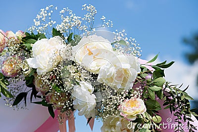 Wedding tradition arch with flower decor on blue sky background Stock Photo