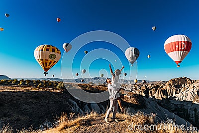 Wedding travel. Honeymoon trip. Couple in love among balloons. A guy proposes to a girl. Couple in love in Cappadocia. Couple in Stock Photo