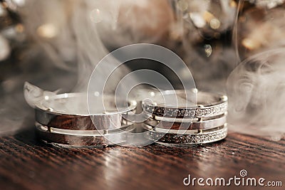 Wedding white rings on the table with smoke Stock Photo