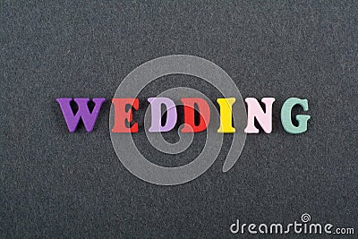 WEDDING word on black board background composed from colorful abc alphabet block wooden letters, copy space for ad text. Learning Stock Photo