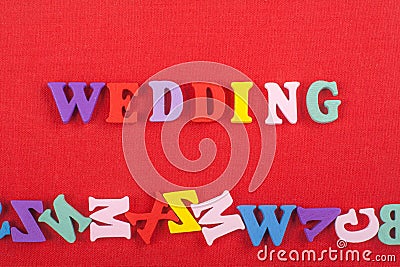 WEDDING word on red background composed from colorful abc alphabet block wooden letters, copy space for ad text. Learning english Stock Photo